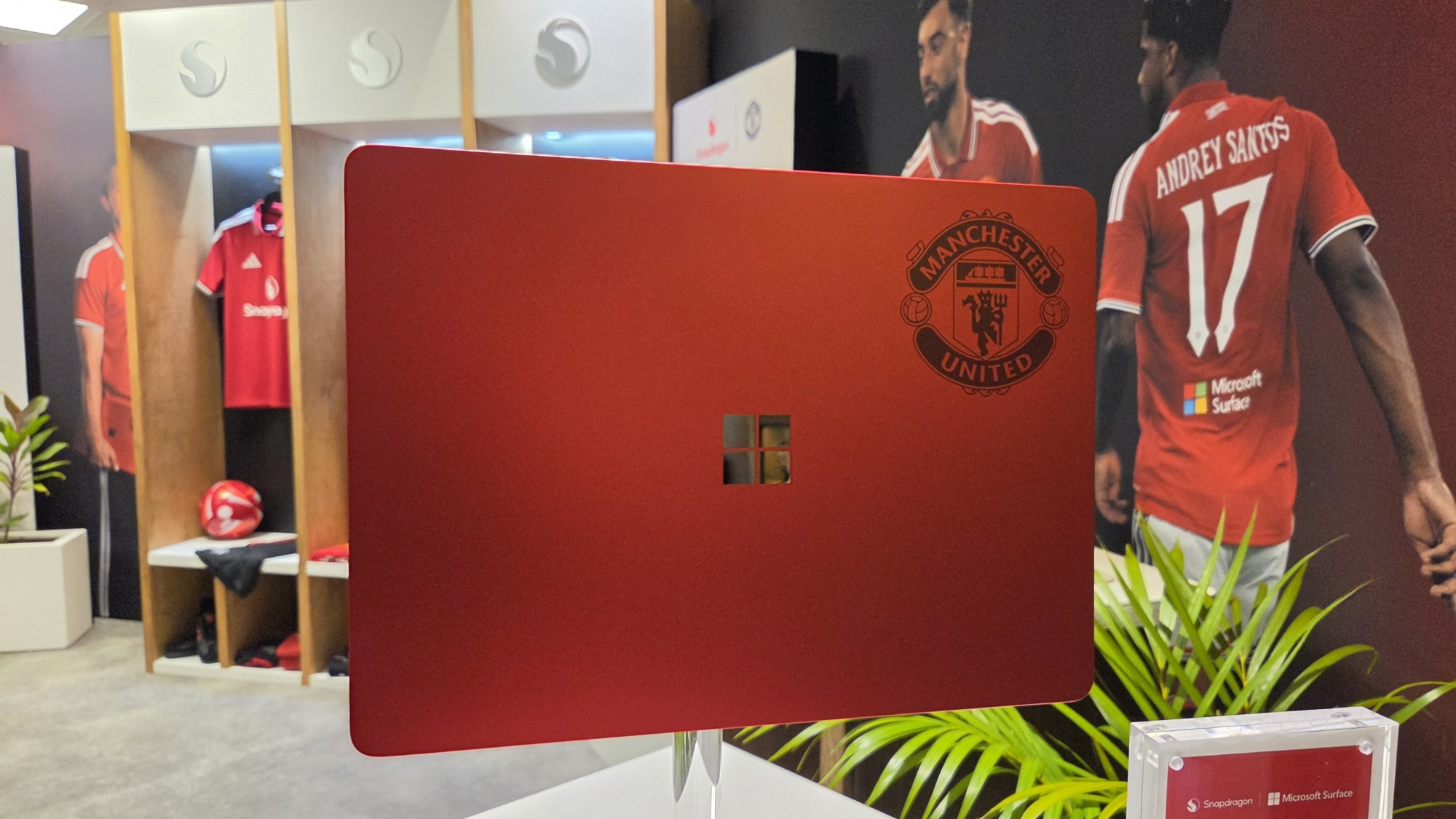 Microsoft Surface Laptop 13-inch 2nd Edition with Manchester United and Qualcomm Snapdragon branding on a red chassis, displayed with football imagery