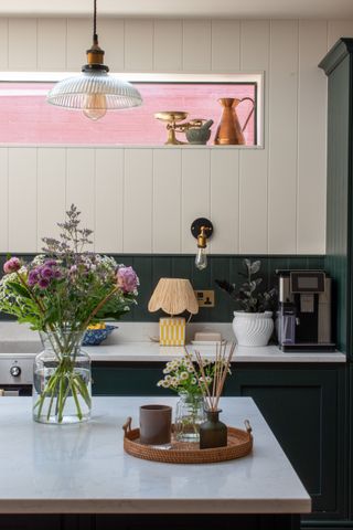 Green kitchen cabinetry with countertop decor