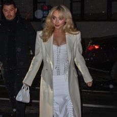 Sabrina Carpenter wears a white corset top.