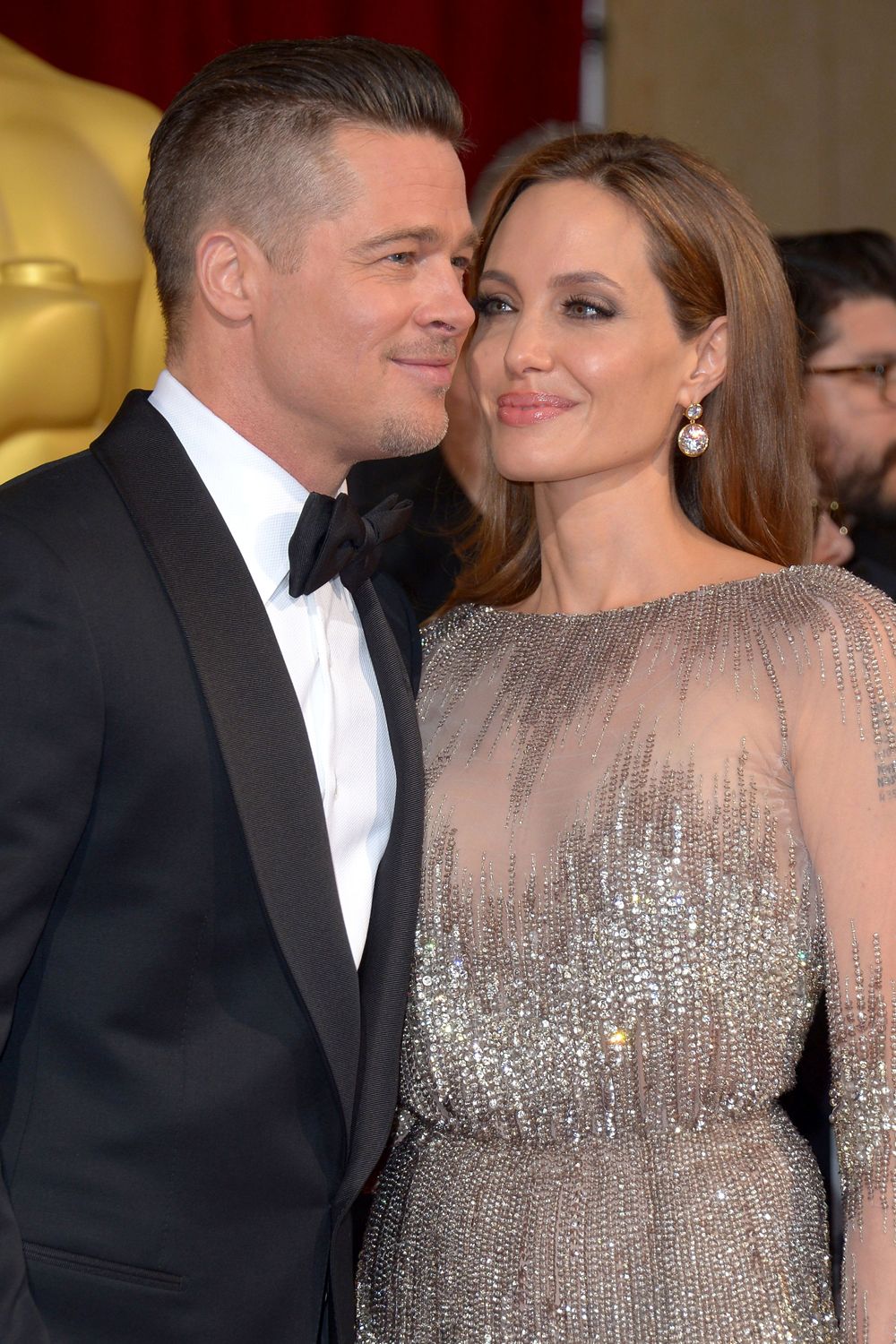 Angelina Jolie and Brad Pitt cosy up on the Oscars 2014 red carpet