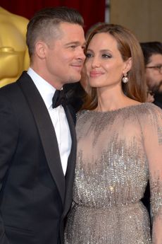 Angelina Jolie and Brad Pitt cosy up on the Oscars 2014 red carpet