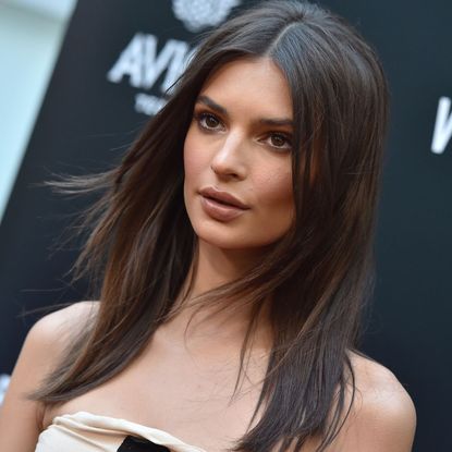 Emily Ratajkowski at a film premier, looking forwards with shoulder length hair