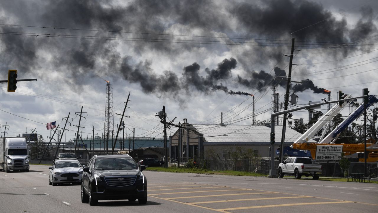 Cars drive past a chemical plant in Norco, Louisiana, in 2021.