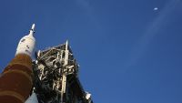 The Orion spacecraft points at the moon from its perch atop the Artemis II Space Launch System (SLS) rocket as it was rolled back to the Vehicle Assembly Building on February 25, 2026.