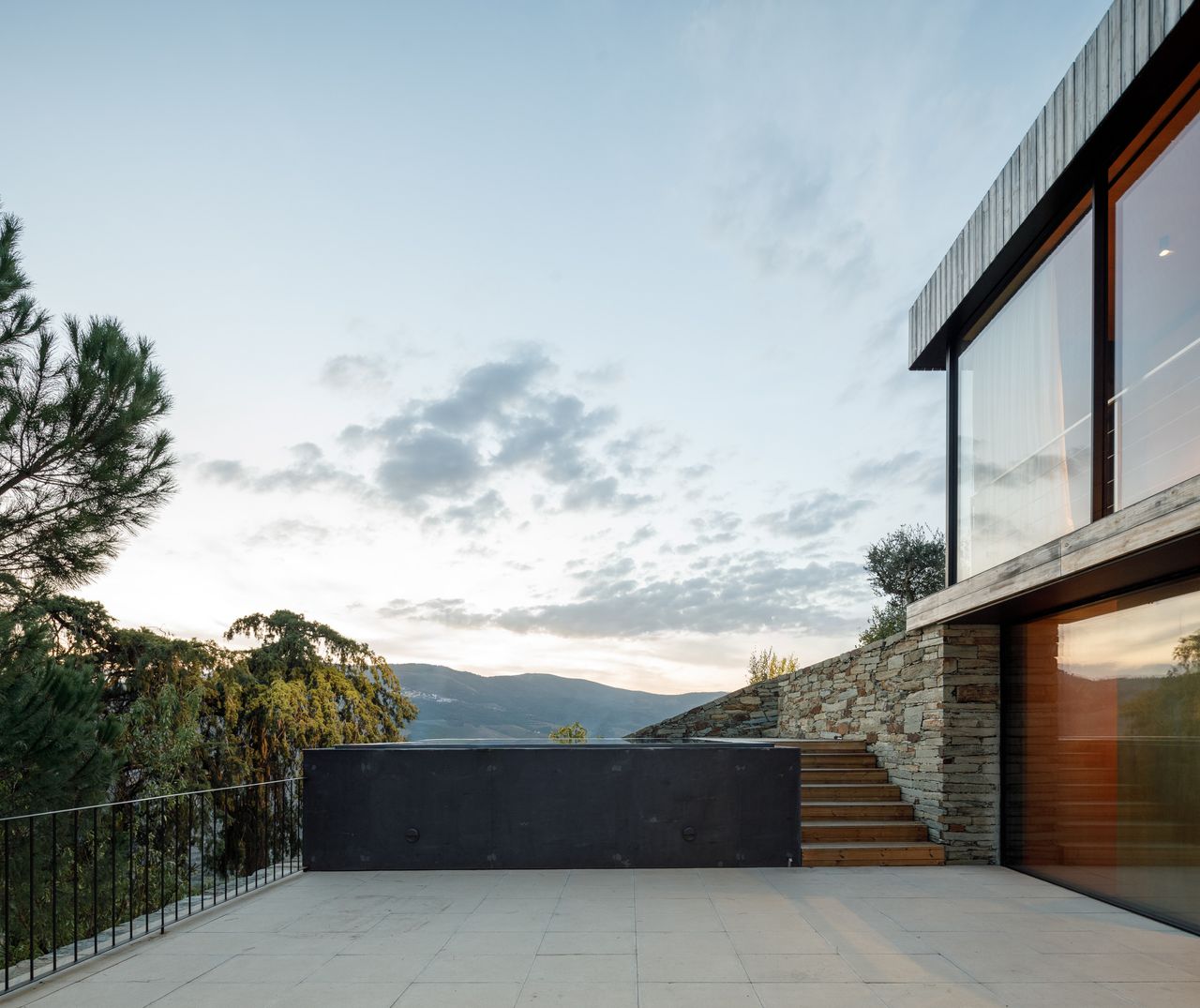 The middle level includes the kitchen and dining area, opening out onto the pool terrace