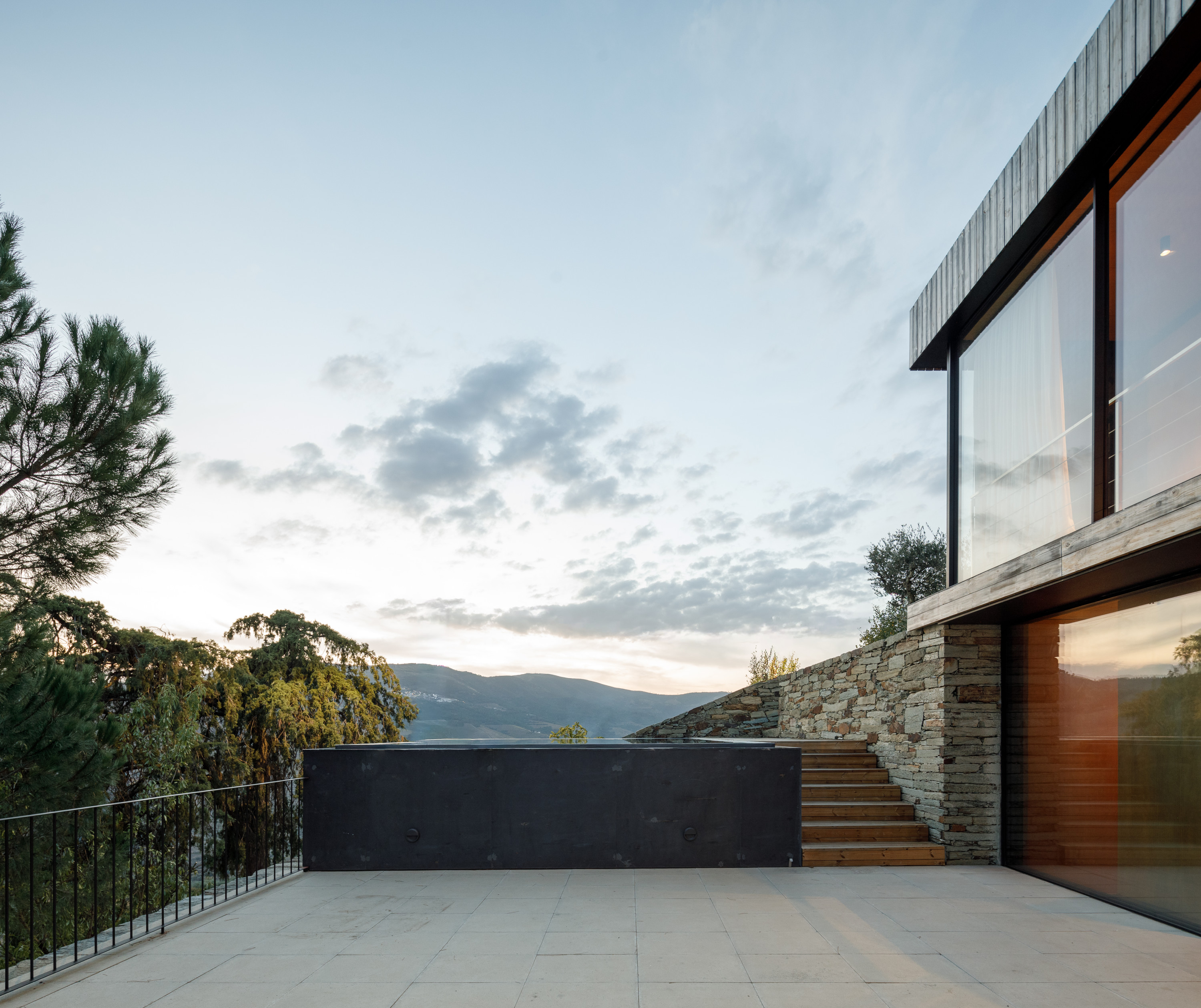 The middle level includes the kitchen and dining area, opening out onto the pool terrace