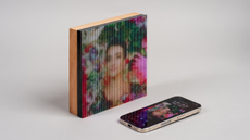 The Tuneshine LED album art display on a light background with an iPhone in front of it