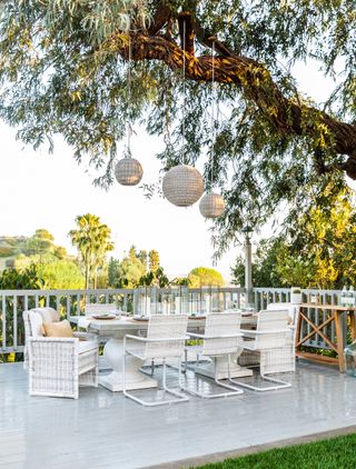 garden shade ideas with outdoor dining table under tree by Marie Flanigan Interiors