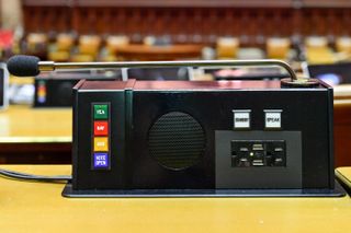 Each desk is equipped with a voting console that includes a custom-designed and custom-fabricated Audix microphone that enables Assembly members to address those in the room.