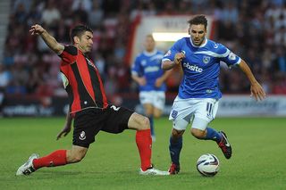 Richard Hughes of Bournemouth looks to try and tackle Portsmouth's Richard Hughes during the Capital One Cup First Round match between AFC Bournemouth and Portsmouth at The Goldsands Stadium on August 06, 2013 in Bournemouth, England