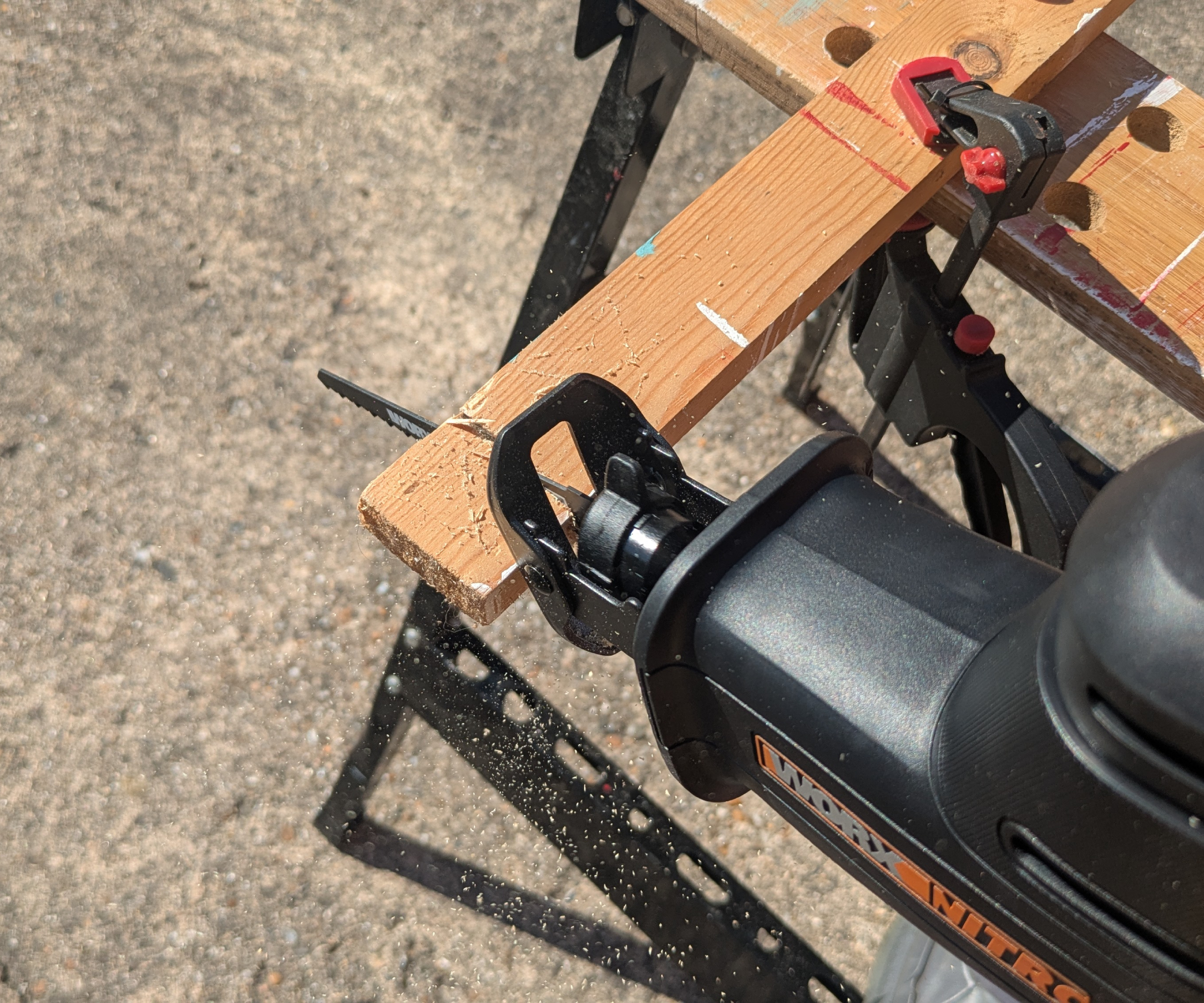 Reciprocating saw cutting through a piece of wood