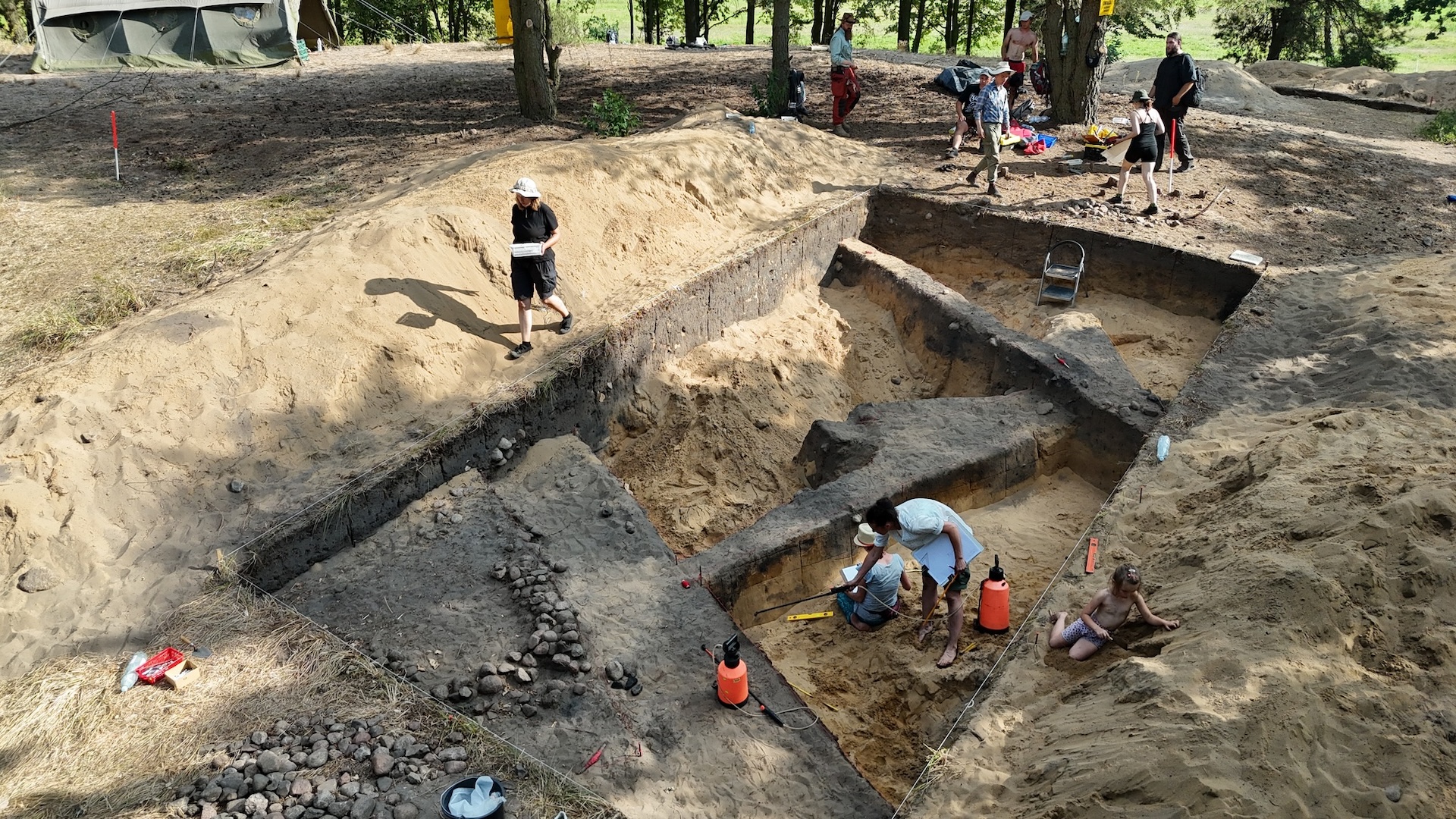 A photo of multiple people working in an excavation site