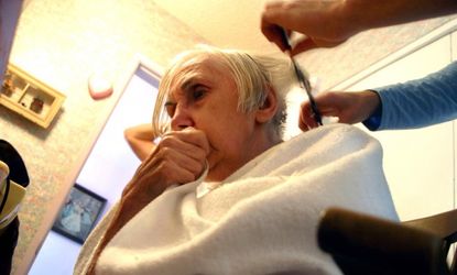 A resident of a California Alzheimer's and dementia facility gets a haircut.