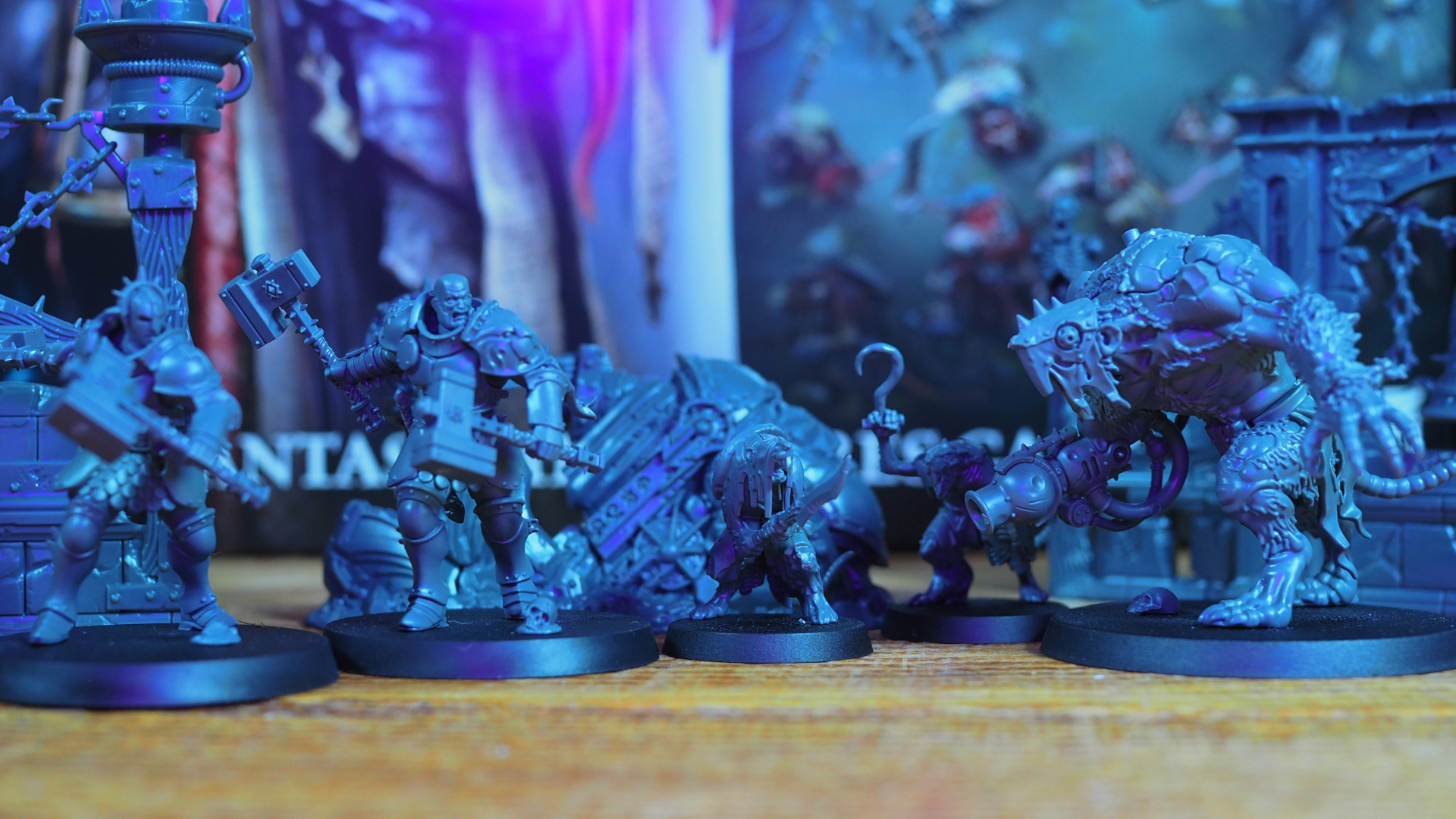 An array of miniatures from the Skaventide box set, on a wooden table