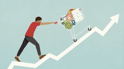 Man pushing shopping cart of groceries up line chart arrow