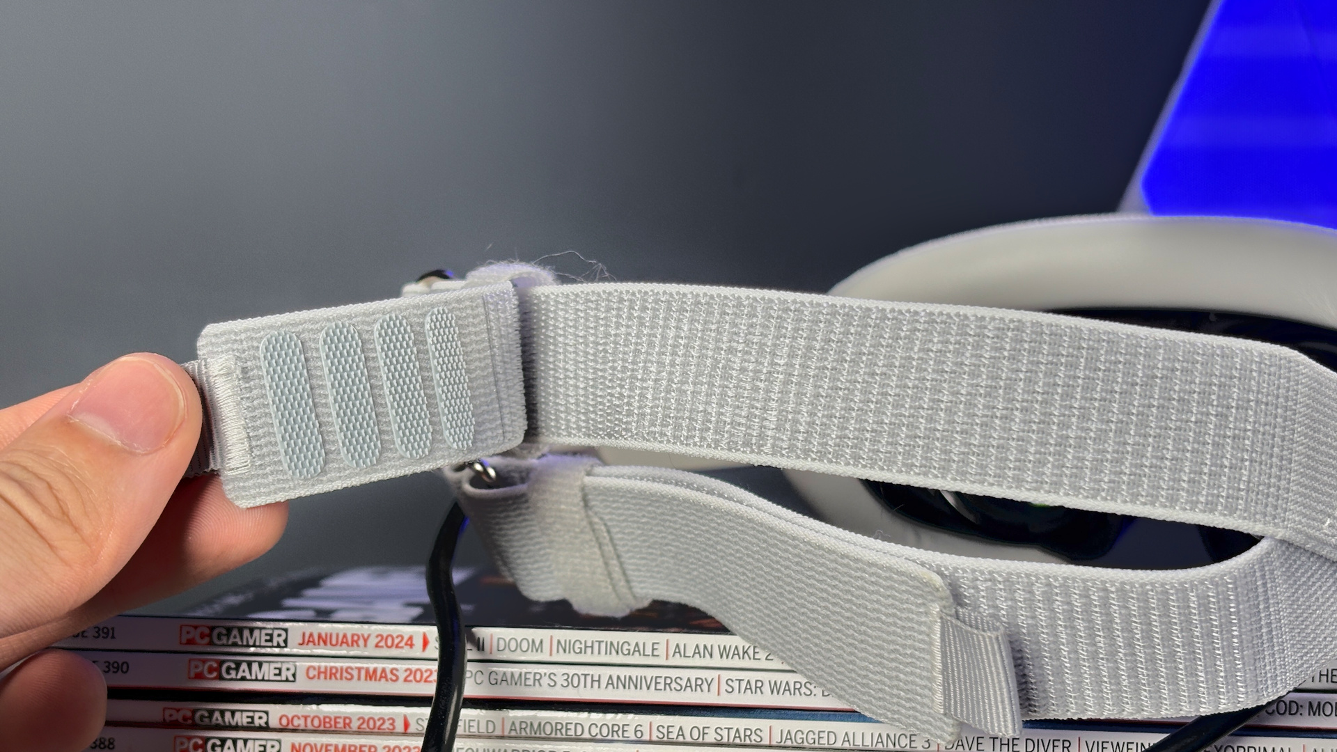 The Pimax Dream Air in white on a stack of PC Gamer magazine.
