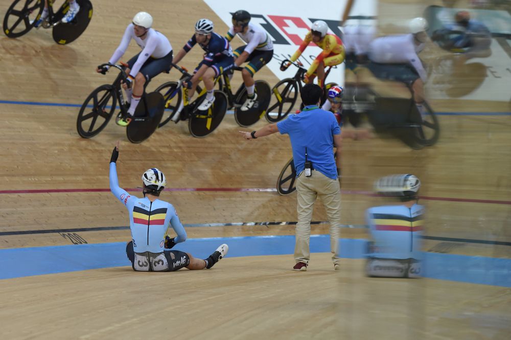 Belgium's Lindsay de Vylder sits on the side after crashing during the men's omnium elimination race 3/4 at the Hong Kong Velodrome