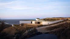 exterior of brutalist home of tom dixon on the hillside in Mykonos