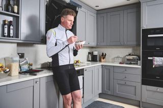 Male cyclist eating a bowl of food based on recommedations from a nutrition app