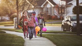 Kids trick or treating while in costume