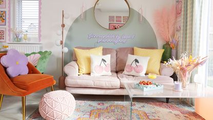 living room with pink sofa and green painted arch on wall