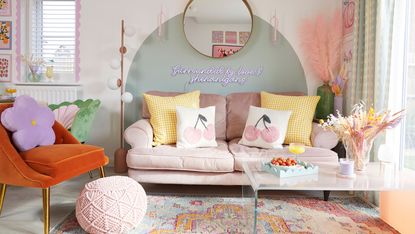 Green living room with mustard velvet sofa and footstool and Victorian-style fireplace