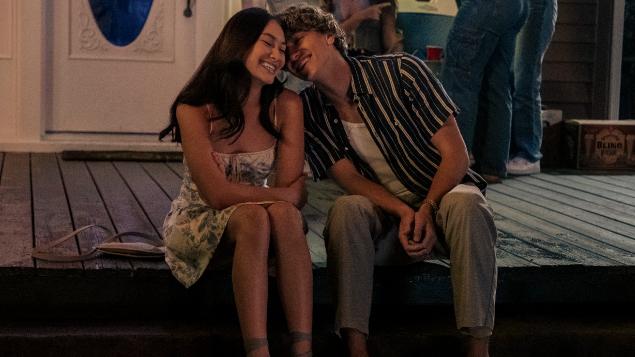 Belly smiling and Jeremiah sitting next to her smiling and leaning into the left side of her face.