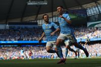 Phil Foden of Manchester City celebrates with teammate Bernardo Silva after scoring his side's first goal against West Ham United on the final day of the 2023/24 Premier League season