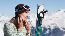 woman applying sunscreen when skiing