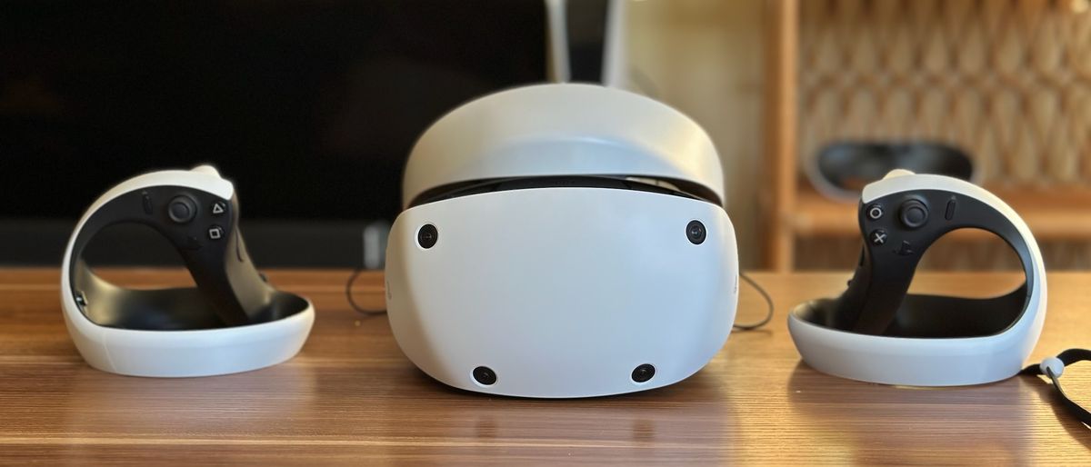 Sony PS VR2 and two Sense controllers sitting on a table.