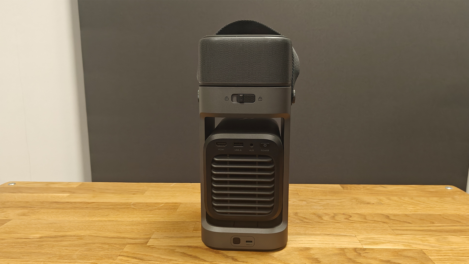 Soundcore Nebula P1 projector on wooden AV rack