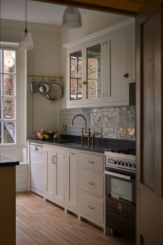 A small kitchen idea with cream cabinetry and glass fronted cabinets in a traditional styledeVOL small kitchen