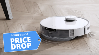 ecovacs deebot t10 plus robot vacuum on hardwood floor with Tom&#039;s Guide Price Drop deal badge on left corner