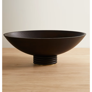 dark wooden bowl in a slim oval design with a ringed stand
