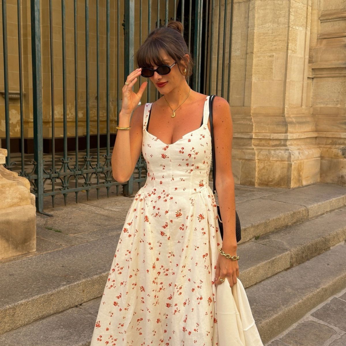Woman wears white dress with red flowers