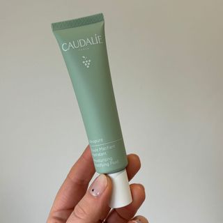Laura holding Caudalie Vinopure Moisturising Mattifying Fluid - best moisturisers for oily skin