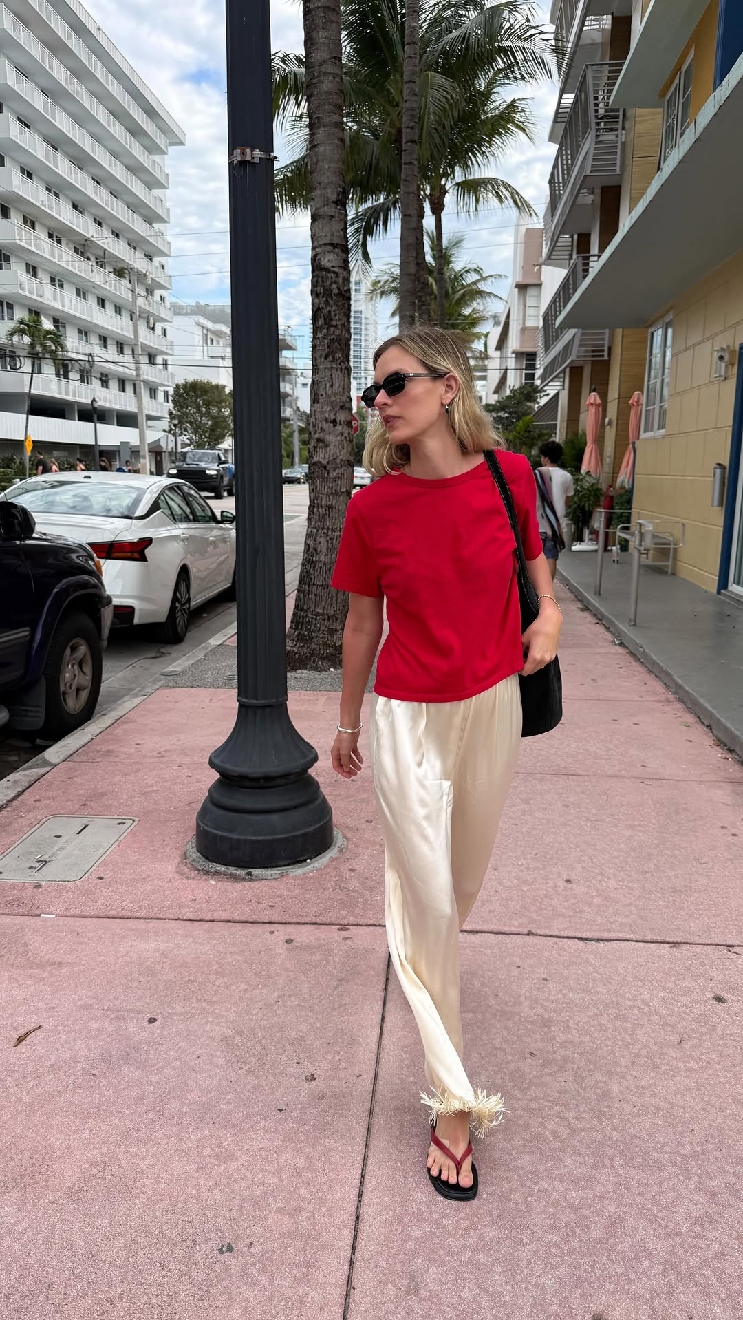 Woman in red t-shirt and satin pants