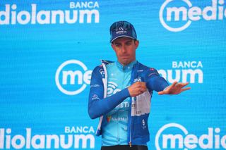 EOLOKometas Italian rider Davide Bais celebrates his best climbers blue jersey on the podium after the twelfth stage of the Giro dItalia 2023 cycling race 179 km between Bra and Rivoli on May 18 2023 Photo by Luca Bettini AFP Photo by LUCA BETTINIAFP via Getty Images
