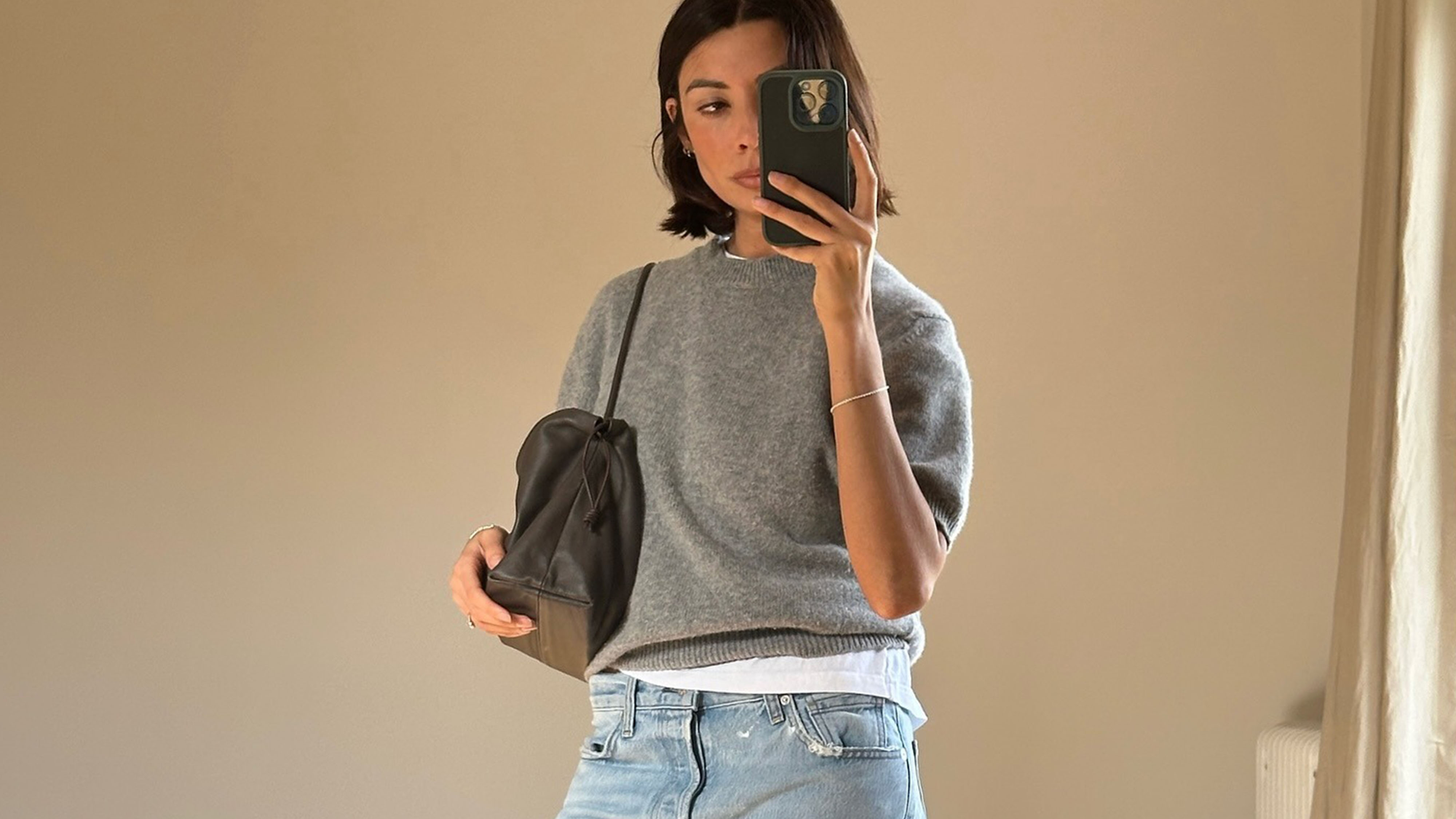Woman in a sweater and jeans.