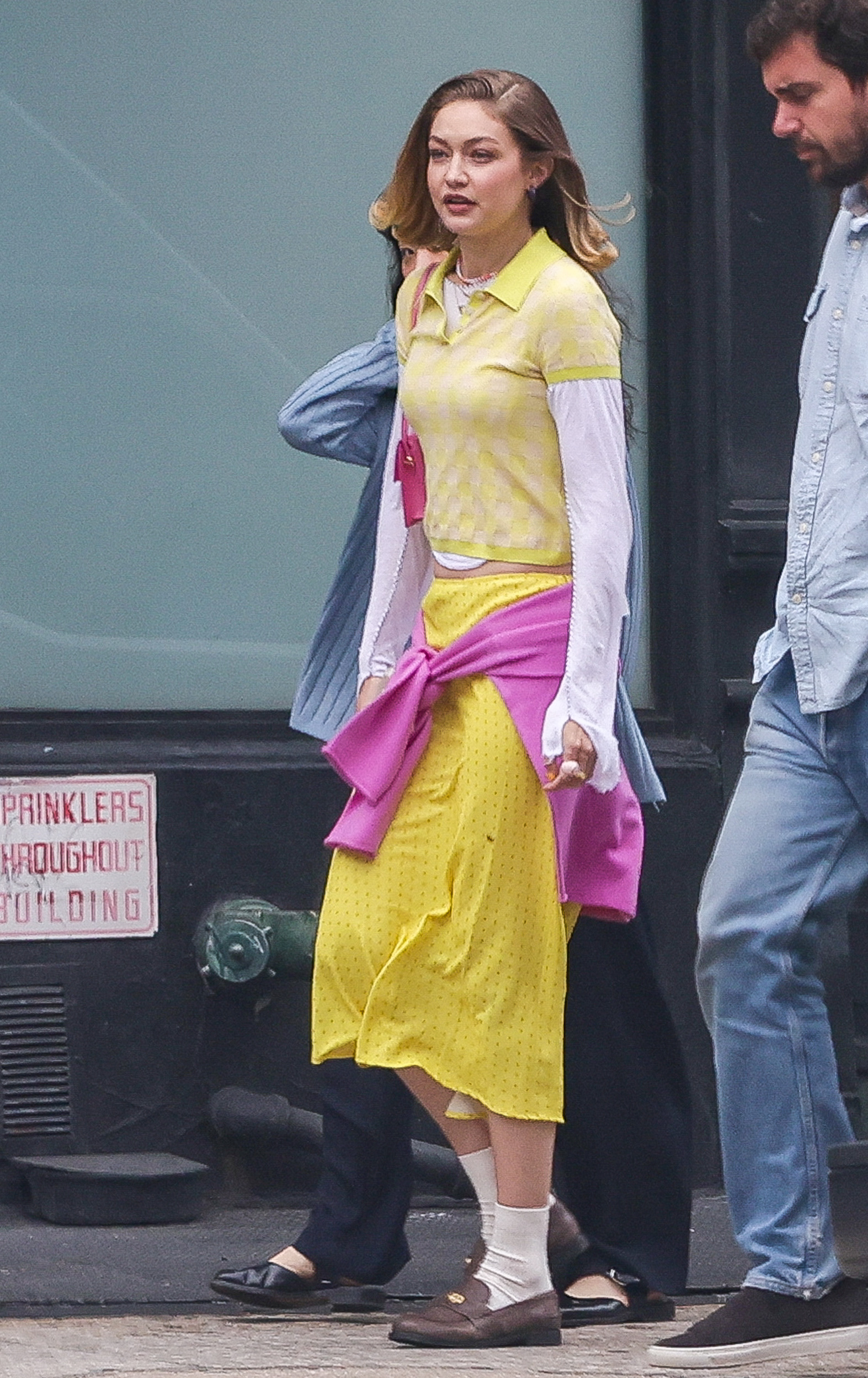 Gigi Hadid is spotted in NYC wearing a yellow look from her brand, Guest In Residence.