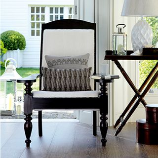 arm chair with wooden floor and table with lamp