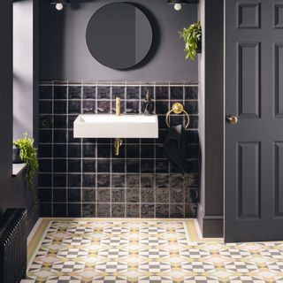 patterned bathroom flooring and black painted walls and black gloss tiles