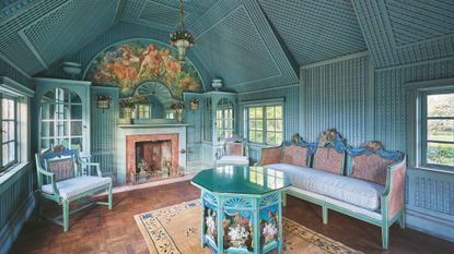 blue-panelled room with blue-green baroque furnishings and wooden parquet floor