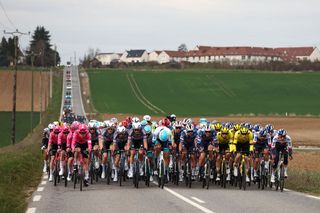 The pack of riders cycles during the 1st stage of the Paris-Nice cycling race, 156,1 km between Le Perray-en-Yvelines and Le Perray-en-Yvelines, on March 9, 2025. (Photo by Anne-Christine POUJOULAT / AFP)