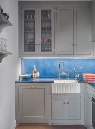 A small kitchen with maximum storage and blue splashback