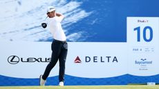 Michael Brennan hits a driver off the tee