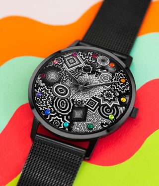 Watch with patterned face on colourful background.