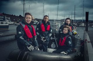 The cast of Annika in a police boat