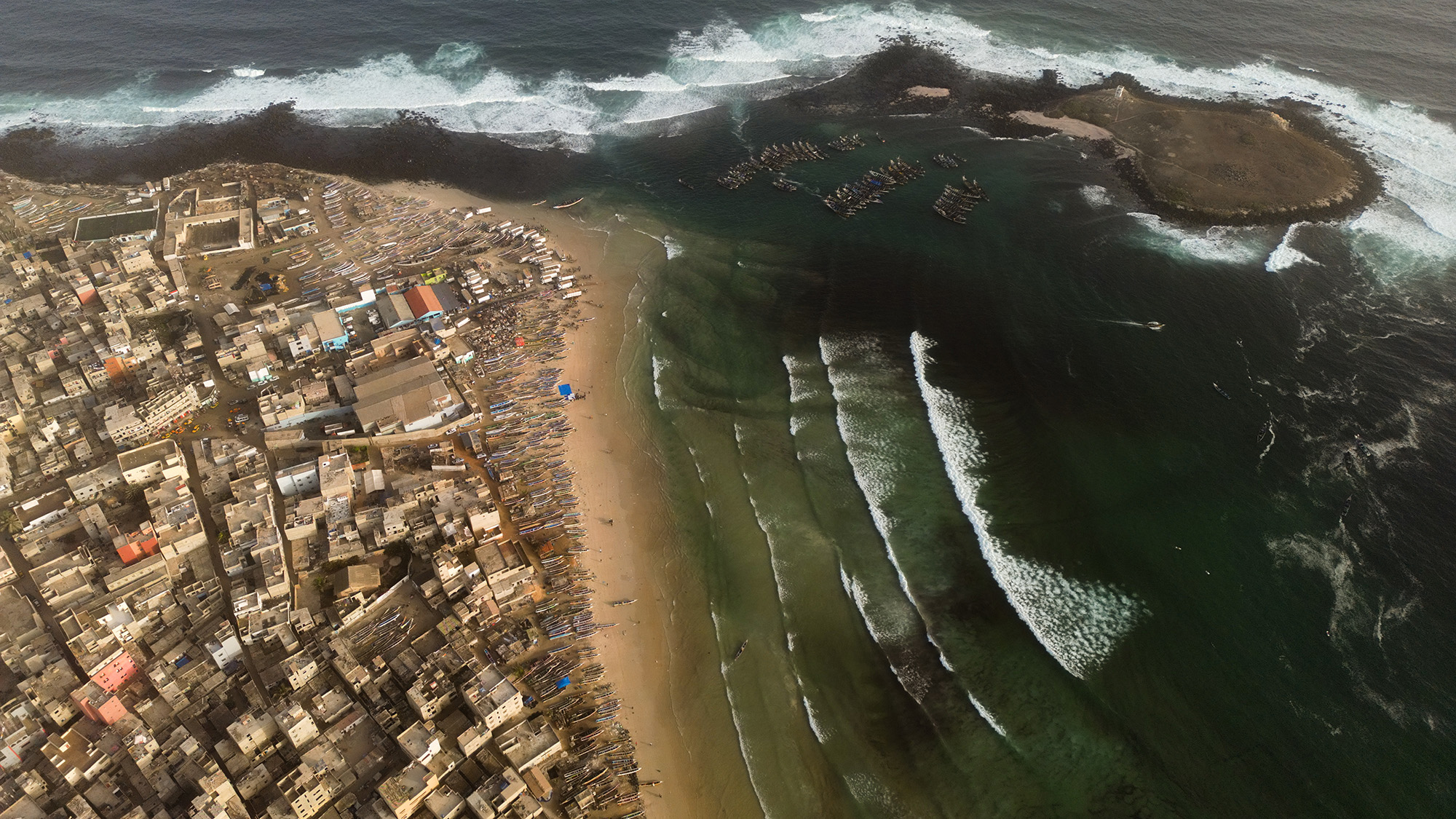 An aerial view of a city next to a coastline.