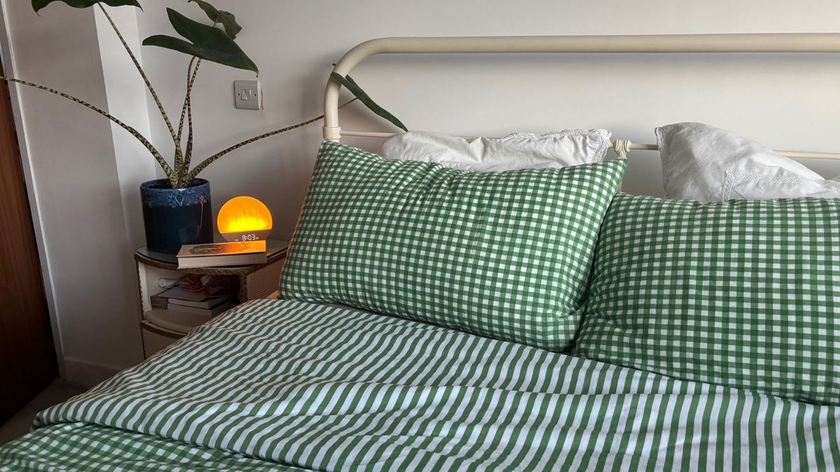 The image shows the Birch Elite Natural mattress dressed in green and white gingham bedding, placed inside a neutrally decorated bedroom
